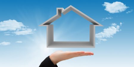 Composite image of hand carrying house with sky background Composite image of hand carrying house with sky background